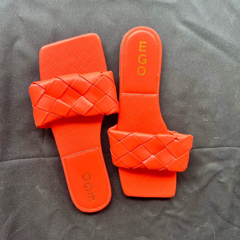 Orange color women’s flats.